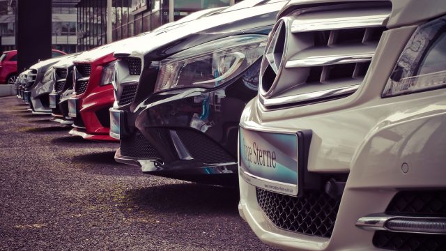 Row of cars lined up at a rental lot