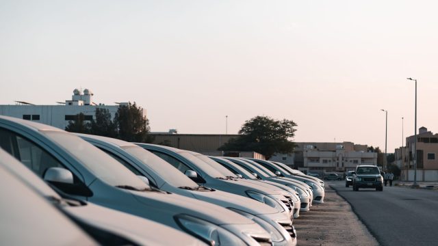 Row of rental cars parked at a pickup lot